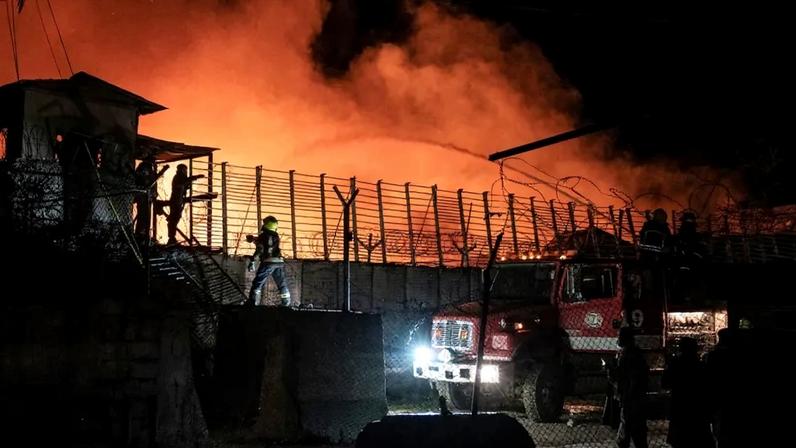 Afghan firefighters and Taliban security personnel work to extinguish a fire at a drug rehabilitation center in Kabul.