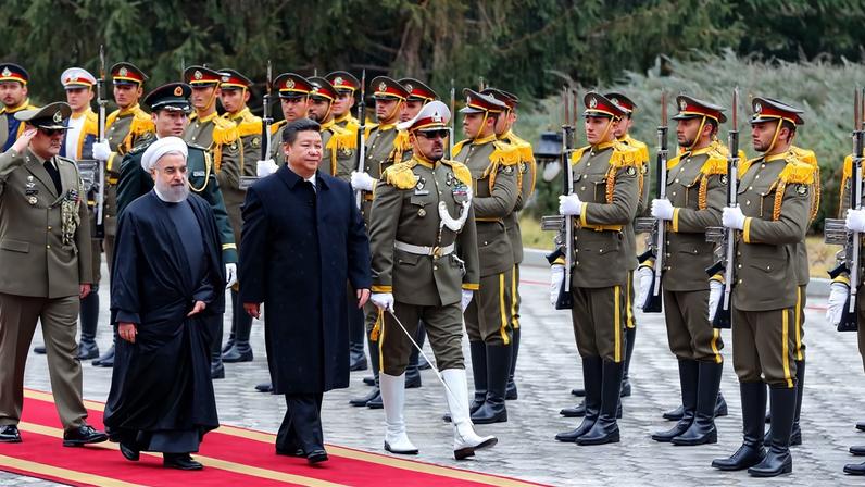 Iranian President Hassan Rouhani (left) and Chinese President Xi Jinping review troops during a welcoming ceremony in Tehran on Jan. 23, 2016.