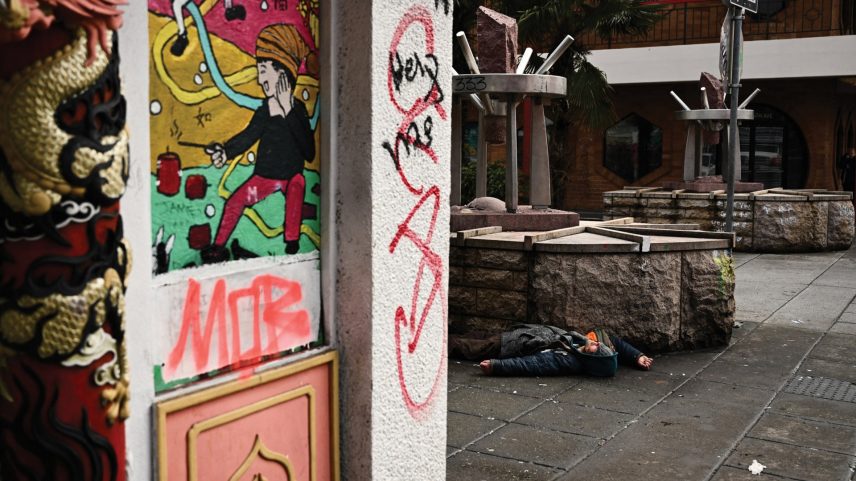 A person lies on the street in the Old Town Chinatown neighborhood on January 25, 2024, following the decriminalization of drugs in Portland, Oregon.