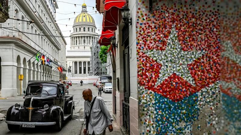 A man walks on a street in Havana.