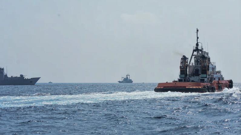 A Sri Lankan Navy tug boat and naval vessels approach an Iranian vessel during a rescue operation, a day after the crew of a distressed Iranian military ship, IRIS Dena were assisted in waters south of Sri Lanka, off the coast of Colombo, Sri Lanka March 5, 2026. Sri Lanka Navy/Handout via REUTERS