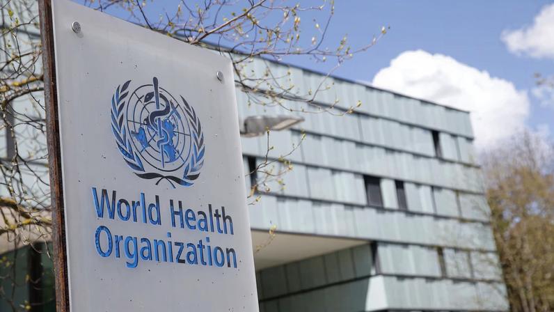 A logo is pictured outside a building of the WHO in Geneva