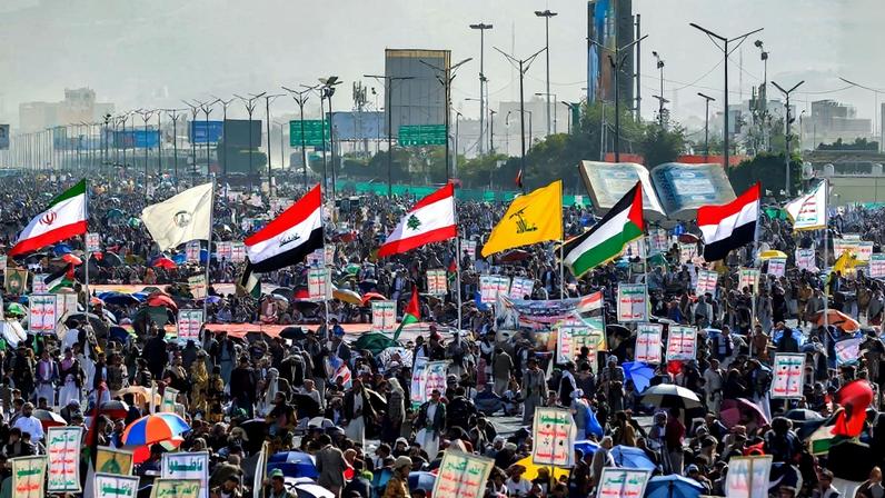 Flags of Yemen, Palestine, Lebanese armed movement Hezbollah, Iraq, Iraqi Hashed Shaabi (Popular Mobilisation Forces or PMF) paramilitary forces, and Iran are raised during a denouncing Israel and in solidarity with Palestinians in the Huthi-controlled capital Sanaa on January 3, 2025.