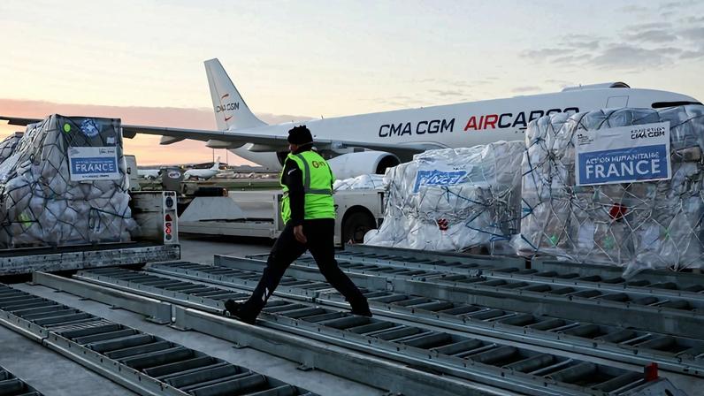 Workers load humanitarian aid into an aircraft destined for Lebanon, seen at Roissy-Charles de Gaulle Airport on the outskirts of Paris on March 12.