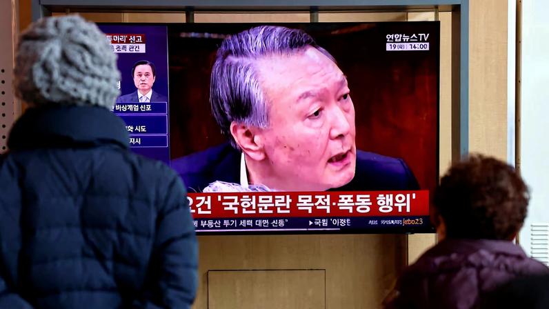 People watch a news report on the sentencing trial of South Korean former president Yoon Suk Yeol's insurrection case, stemming from his short-lived declaration of martial law in December 2024, in Seoul, South Korea, February 19, 2026. REUTERS/Kim Soo-hyeon