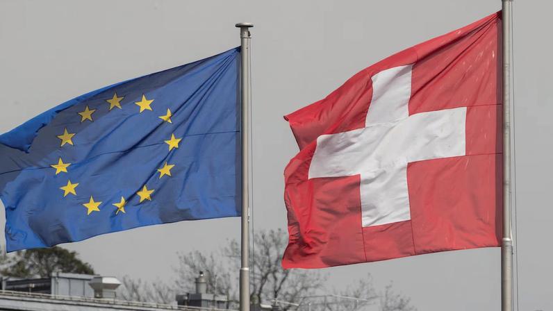 Switzerland's national flag flies beside the one of the European Union in Zurich, Switzerland May 3, 2022. REUTERS/Arnd Wiegmann