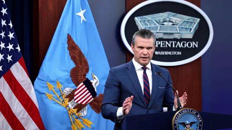 U.S. Defense Secretary Pete Hegseth speaks during a news conference at the Pentagon while standing in front of a U.S. flag.