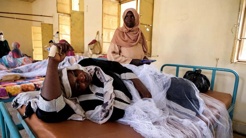Sudanese women lie in beds as they receive treatment for dengue fever at Omdurman Hospital, as Sudan grapples with outbreaks of dengue and cholera amid the annual rainy season and a collapsed healthcare and infrastructure system, in Khartoum