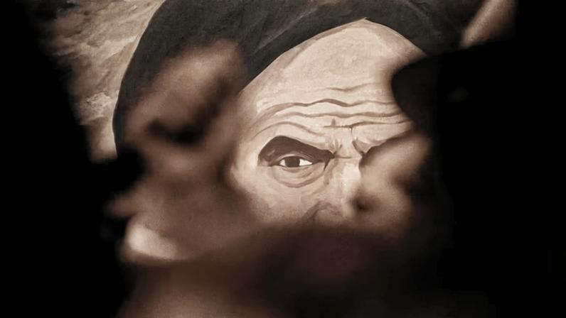 Cartel con un dibujo del líder de la revolución iraní, el ayatolá Jomeini.