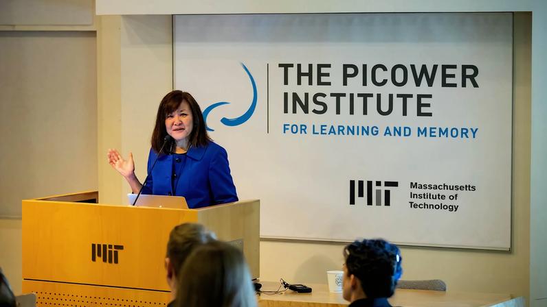 Picower Professor Li-Huei Tsai speaks at a symposium of The Picower Institute for Learning and Memory, an MIT neuroscience research institute she has led for more than 16 years.