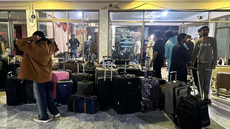 Pakistani students stand next to their luggage after their reutrn from Iran, amid the U.S.-Israeli conflict with Iran, in Quetta, Pakistan, March 4, 2026. Picture taken with a mobile phone.