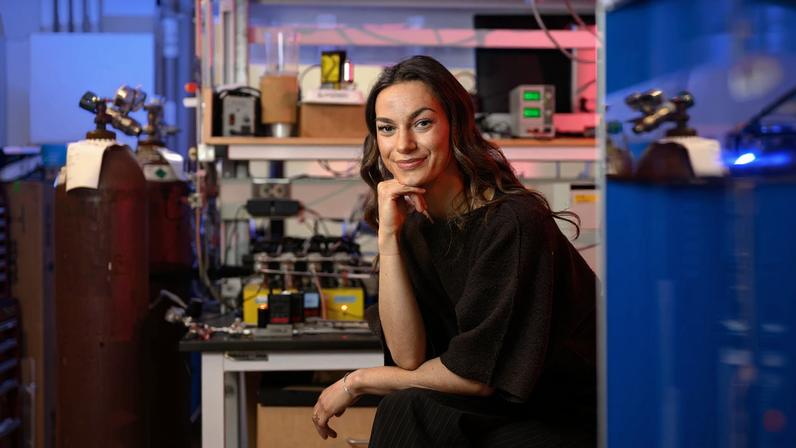 Audrey Parker seated in lab with blue lighting.
