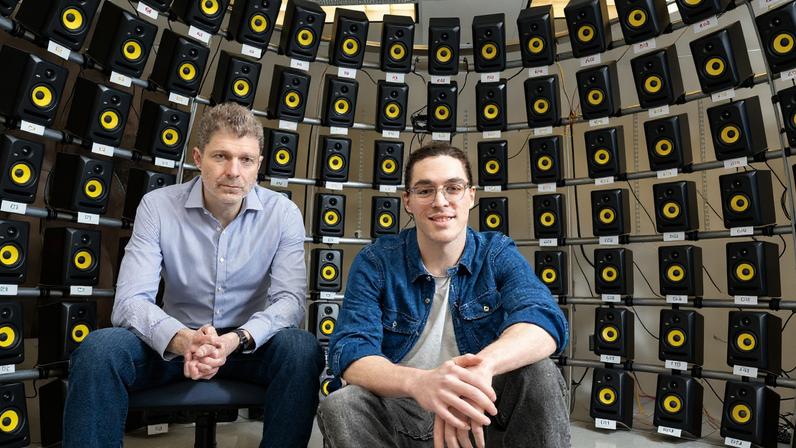 Josh McDermott (left), professor of brain and cognitive sciences and associate investigator at the McGovern Institute sits with graduate student Ian Griffith in the speaker array room where they conducted the study.