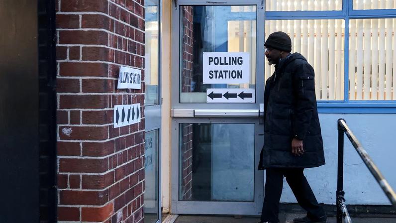 A man arrives at a polling station at Abbey Hey Primary Academy to vote in the Gorton and Denton by-election, triggered by the resignation of Andrew Gwynne, in Gorton, Manchester, Britain, February 26, 2026. REUTERS/Temilade Adelaja
