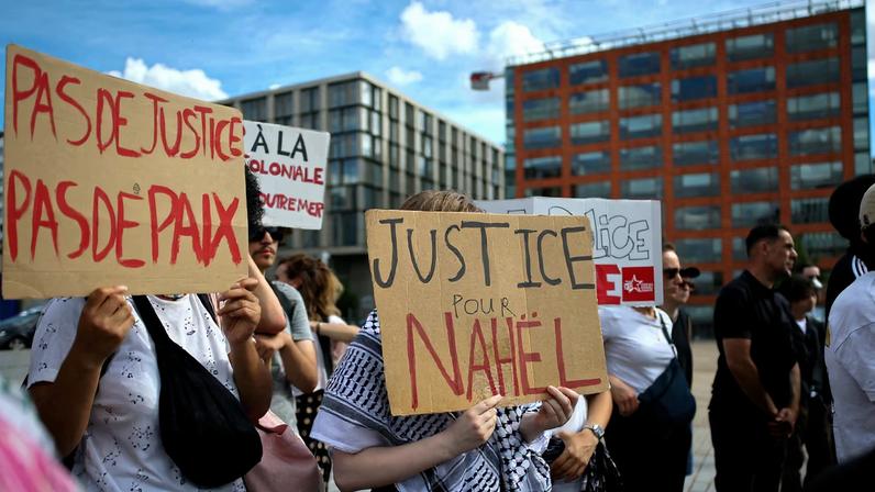 People hold placards during a demonstration to demand justice two years after the death of Nahel, a 17-year-old teenager killed by a French police officer during a traffic stop, in Nanterre, near Paris, France, June 27, 2025.