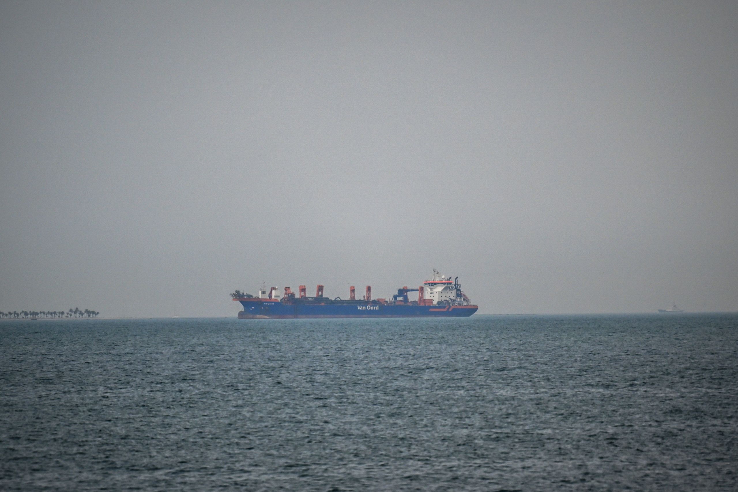 A commercial ship is viewed anchored off the coast of the United Arab Emirates, in the Strait of Hormuz.