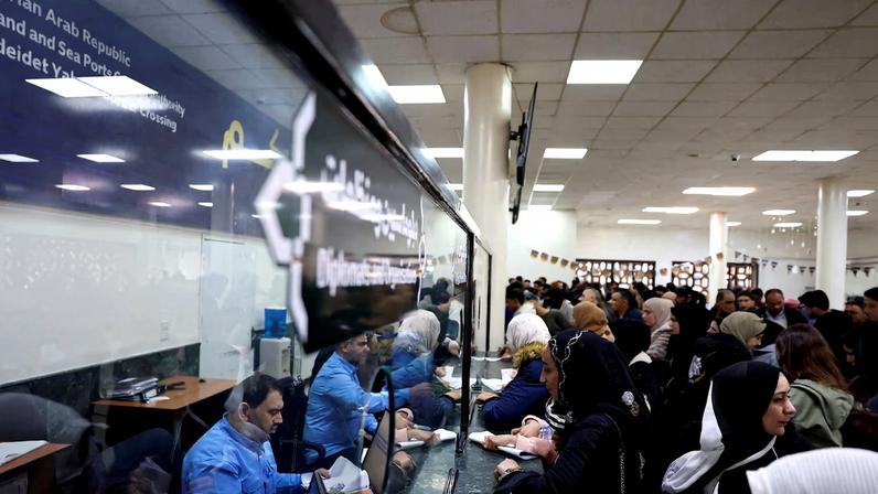 Syrians living in Lebanon wait at the Ministry of Interior Immigration and Passports Department, at the Syrian-Lebanese border, as they return to Syria due to ongoing hostilities between Hezbollah and Israeli forces, amid the U.S.-Israeli conflict with Iran, in Jdaydet Yabous, Syria, March 3, 2026. REUTERS/Yamam Al Shaar
