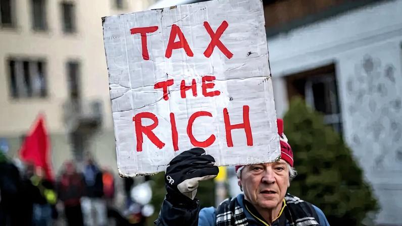 Phil White, a member of Patriotic Millionaires UK, participates in a demonstration ahead of the World Economic Forum in Davos, Switzerland, on Jan. 19, 2025.