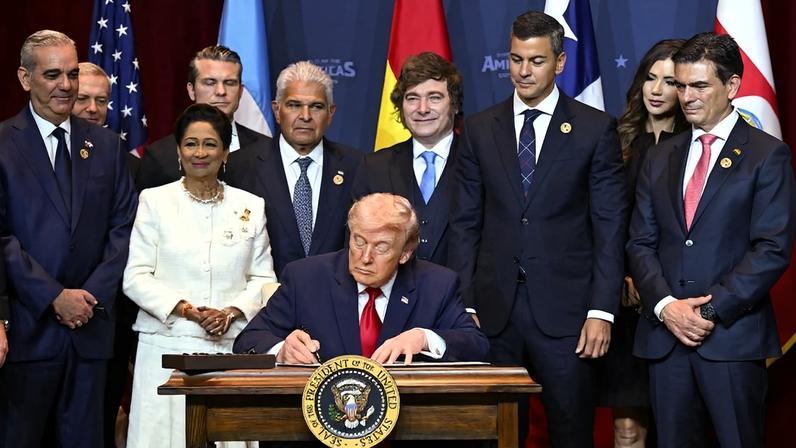 U.S. President Donald Trump signs a proclamation at the Shield of the Americas Summit in Miami on March 7.