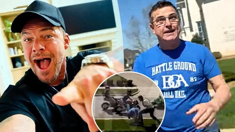 Alan Ritchson in a black cap and shirt, winking and smiling.