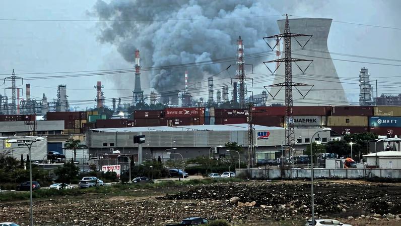 Smoke rises from an oil refinery that was damaged in an Iranian attack, amid the U.S.-Israel conflict with Iran, in Haifa, Israel, March 19, 2026. REUTERS/Sharon Sztrozenberg