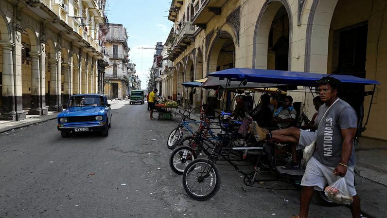 A man walks carrying groceries as U.S.-Cuba tensions rise after U.S. President Donald Trump vowed to stop Venezuelan oil and money from reaching Cuba and suggested the communist-run island to...