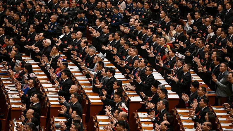 Delegates applaud during a plenary session of China's National People's Congress.