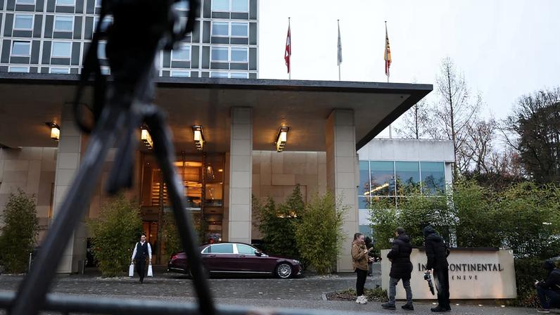 People stand near the InterContinental hotel as the U.S.-mediated peace talks continue between Russia and Ukraine in Geneva, Switzerland, February 18, 2026. REUTERS/Pierre Albouy/ File Photo