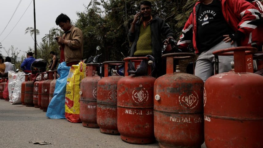 People stand in a queue with their empty LPG cylinders outside a depot of Nepal Gas Industries Pvt. Ltd. amid the U.S.-Israeli conflict with Iran, in Kathmandu