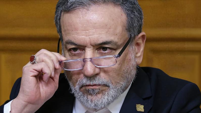 Iranian Foreign Minister Abbas Araqchi adjusts glasses during a press conference following talks with Russian Foreign Minister Sergei Lavrov in Moscow, Russia, December 17, 2025. REUTERS/Ramil Sitdikov/Pool/File Photo