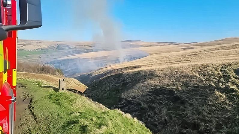 West Yorkshire Fire and Rescue Smoke billowing from a wildfire on Marsden Moor