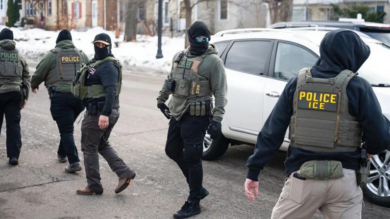Federal agents walk through a neighborhood in Minneapolis, Minnesota on Feb. 5.