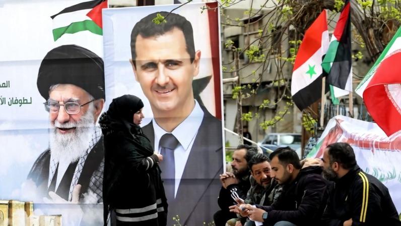 Portraits of Syrian President Bashar al-Assad and Iranian Supreme Leader Ayatollah Ali Khamenei are seen in the Yarmouk district of Damascus, Syria, on March 26, 2024.