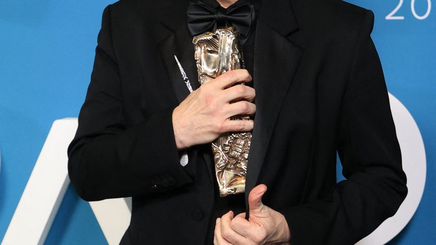 Jim Carrey holding the Honorary César Award.