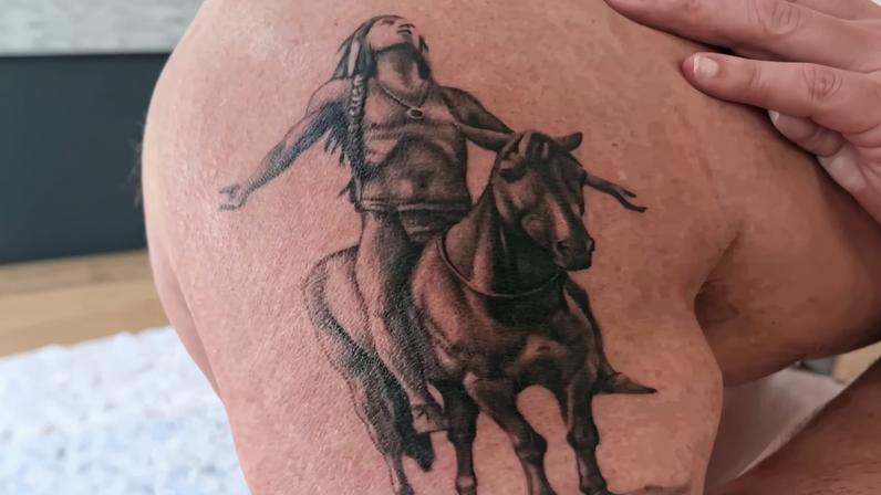 John Stamos shows off his first tattoo, a Native American horseback rider looking skyward.