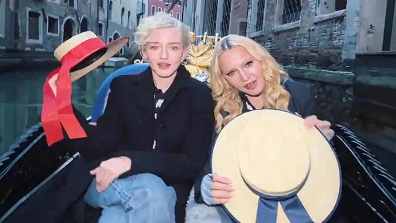 Madonna and Julia Garner rode on a gondola in Venice together, lip-syncing to “Like A Virgin.”