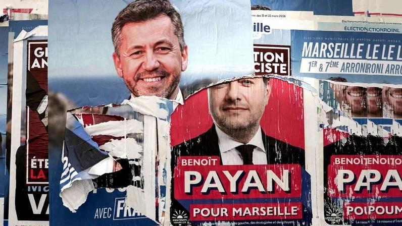 A torn election poster for Franck Allisio, the Marseille mayoral candidate from France’s far-right National Rally party, atop a poster for the incumbent mayor, Benoît Payan, seen in Marseille on March 1.