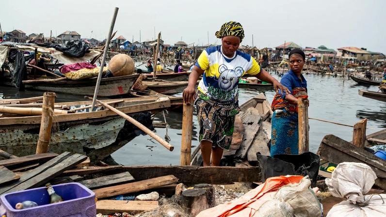 Residents evacuate in a boat following forceful eviction and demolition of homes in the Makoko slum in Nigeria.