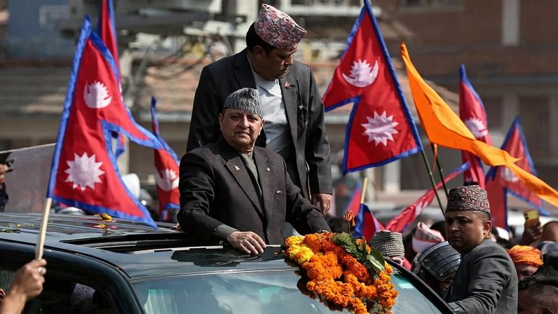 Former Nepali King Gyanendra Shah greets supporters in Kathmandu, Nepal, on Feb. 13.