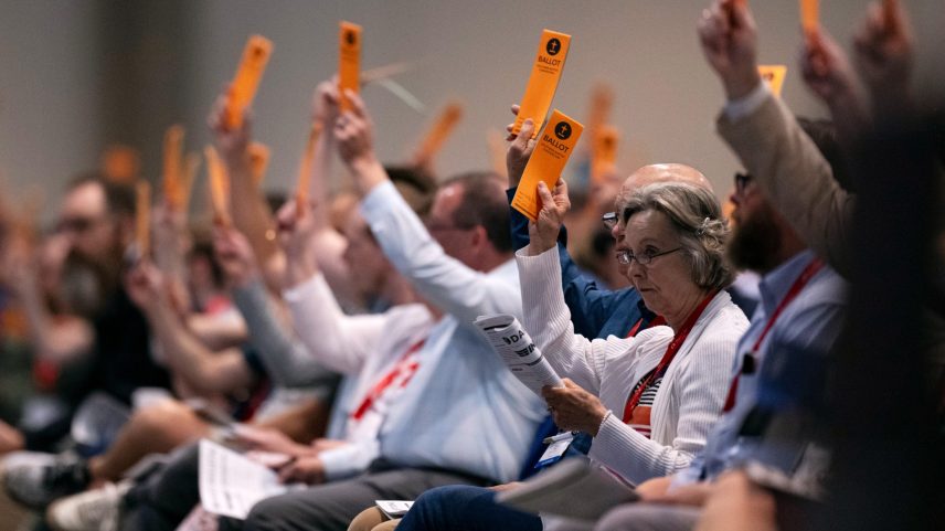 Messengers raise their ballots to vote during a Southern Baptist Convention annual meeting on June 11, 2024, in Indianapolis.