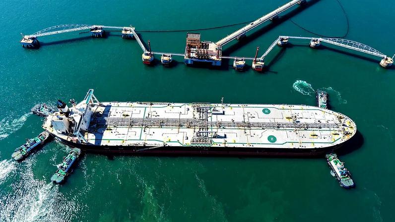 An aerial view as a crude oil tanker is guided to a berth at the oil terminal at the port in Qingdao, in China's eastern Shandong province.