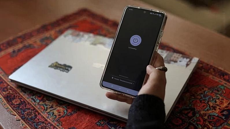 Woman shows her phone during Iran's internet shutdown in Tehran