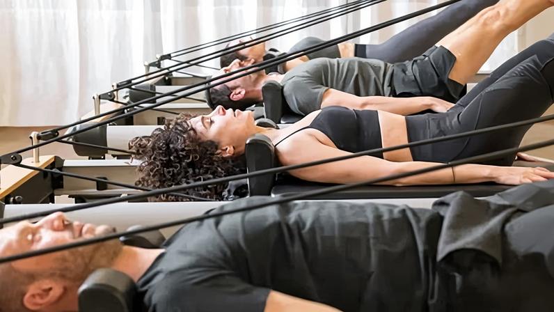 Reformer pilates is a full-body workout performed on a machine with a sliding carriage, springs, straps and a foot bar.