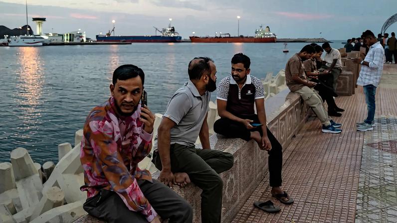 People celebrate Eid and watch oil tankers sail into Muscat Anchorage on March 22 at Sultan Qaboos Port in Muscat, Oman.