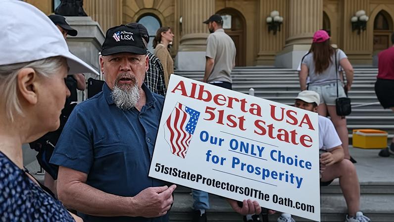 Un hombre sostiene una pancarta en la que se lee "Alberta, 51º Estado de EE UU. Nuestra ÚNICA opción para la prosperidad", frente a la Asamblea Legislativa de Alberta tras la victoria electoral del primer ministro Mark Carney, en mayo de 2025.