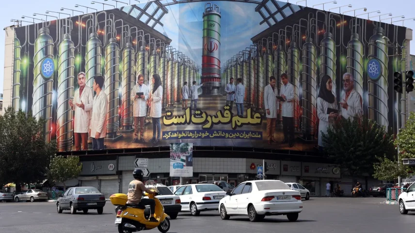 A billboard displaying pictures of nuclear scientists, centrifuges and a sentence reading in Farsi: " Science is the power", at the Enqelab square in Tehran, on August 29, 2025.