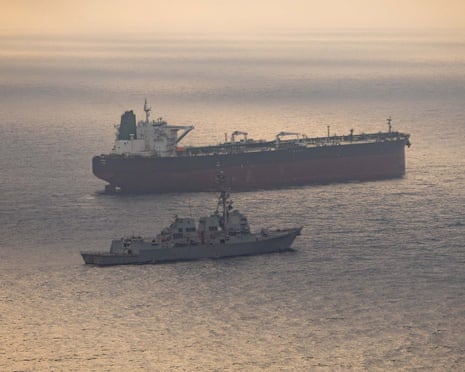 The USS Rafael Peralta (top) last month near what the US military said was a vessel attempting to sail to an Iranian port amid the US blockade.