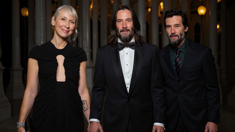 Alexandra Grant and Keanu Reeves walking arm-in-arm at MOCA Benefit in Los Angeles.