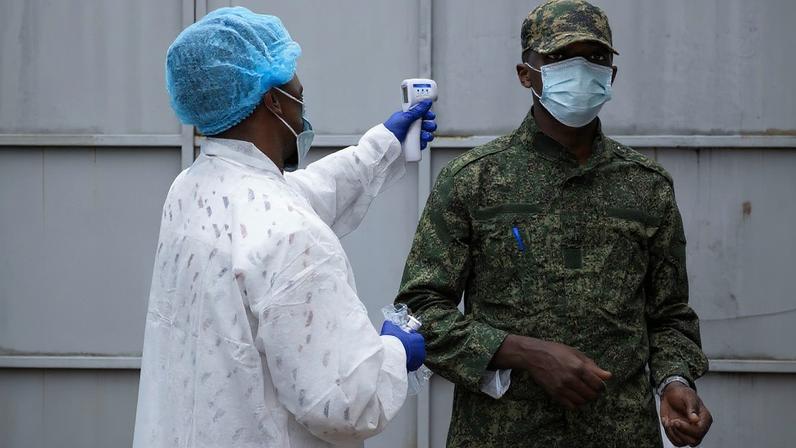 A health worker takes the temperature of an M23 rebel at the entrance to the Rodolphe Merieux Laboratory, National Biomedical Research Institute (INRB), where samples from suspected Ebola cases are examined, as part of the response to the epidemic in Goma, North Kivu province of the Democratic Republic of Congo, May 19, 2026. REUTERS/Arlette Bashizi