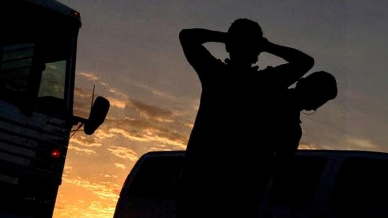 A migrant from El Salvador is put on a plane in Phoenix for deportation to his home country.